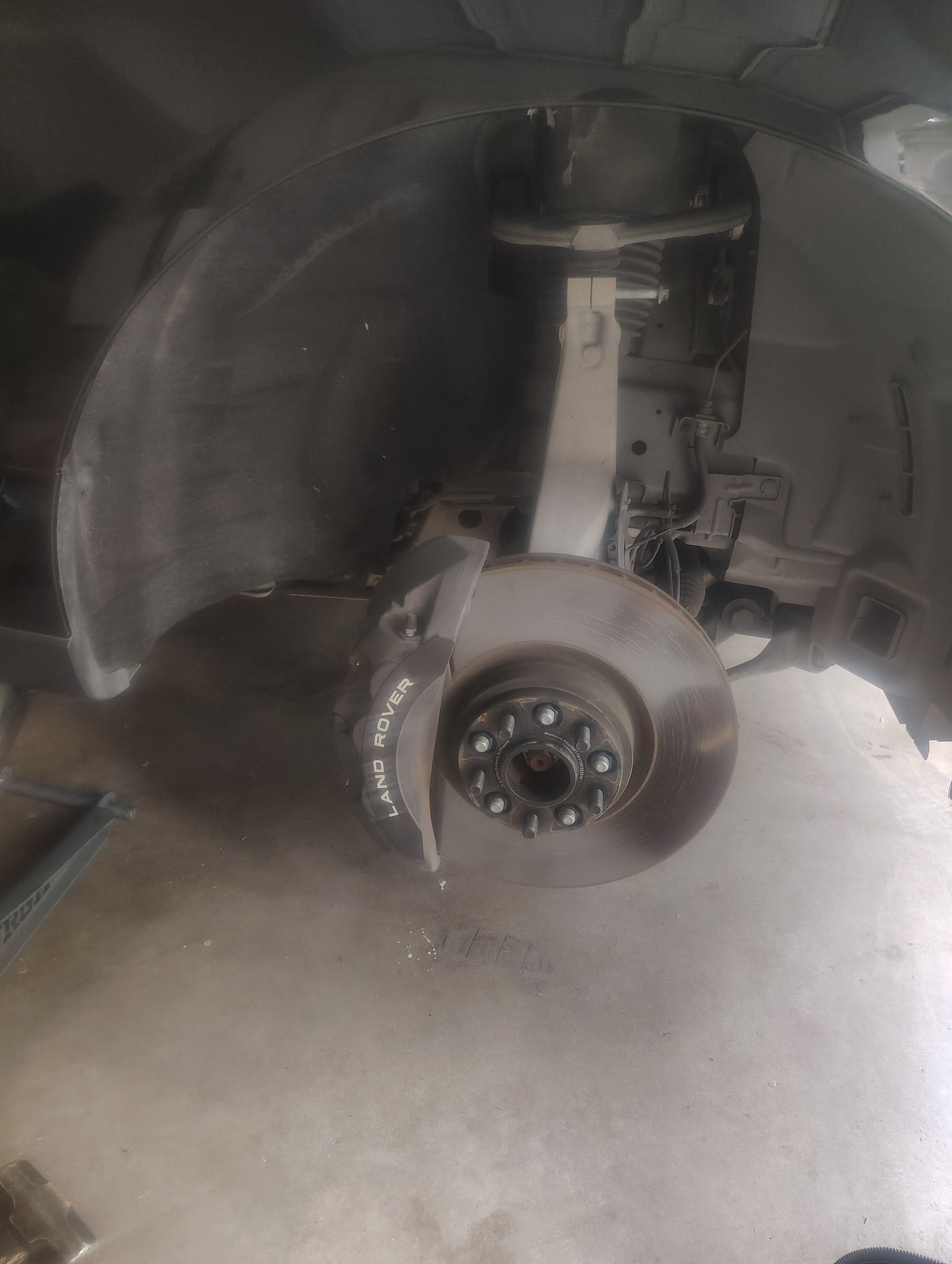 A close up of a brake disc on a car.