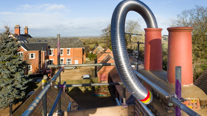 A chimney with a hose attached to it is being worked on.
