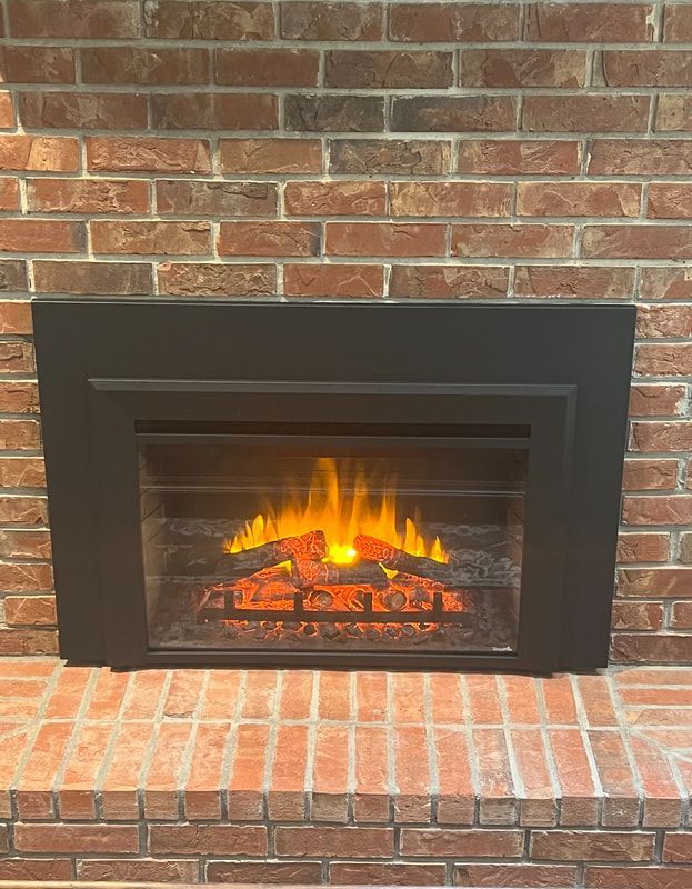 Modern electric fireplace installed in brick wall by Chimney Keeper experts.