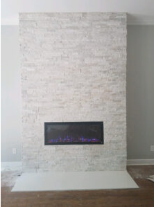 Modern white stacked-stone electric fireplace installation in living room.