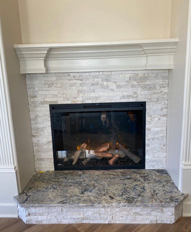 Elegant white-stone fireplace remodel with marble hearth and clean chimney flue.
