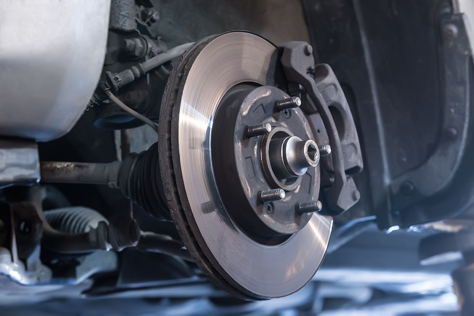 Close-up of car brake assembly showing brake pads and rotor