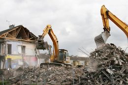 two excavators demolishing building