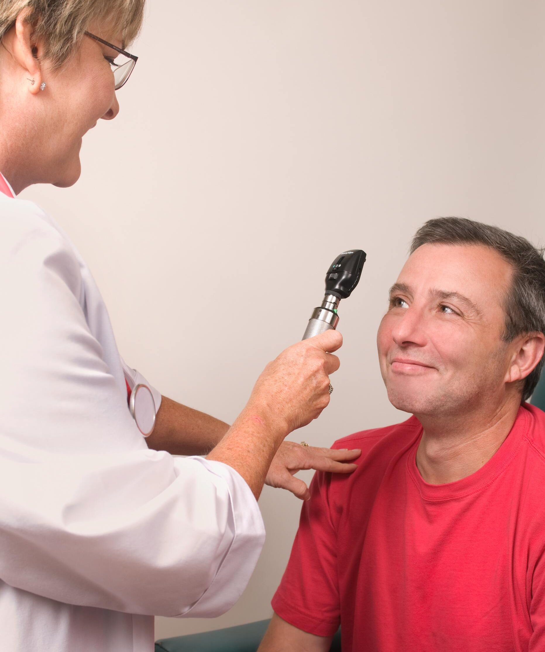 woman giving eye exam to man