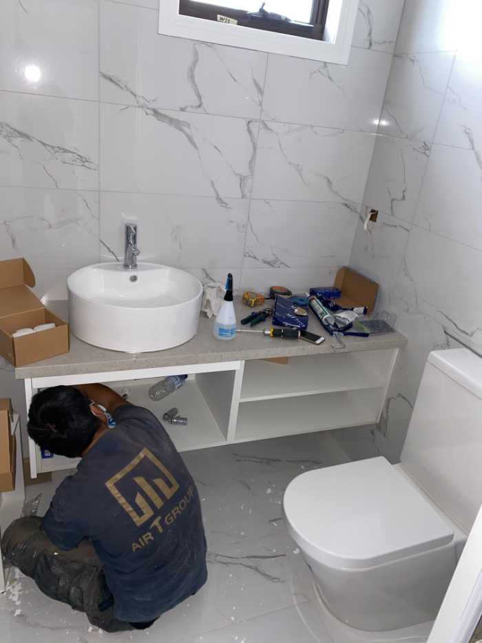 man installing bathroom fittings