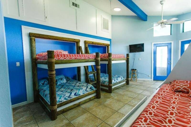 A room with bunk beds and a teepee in it