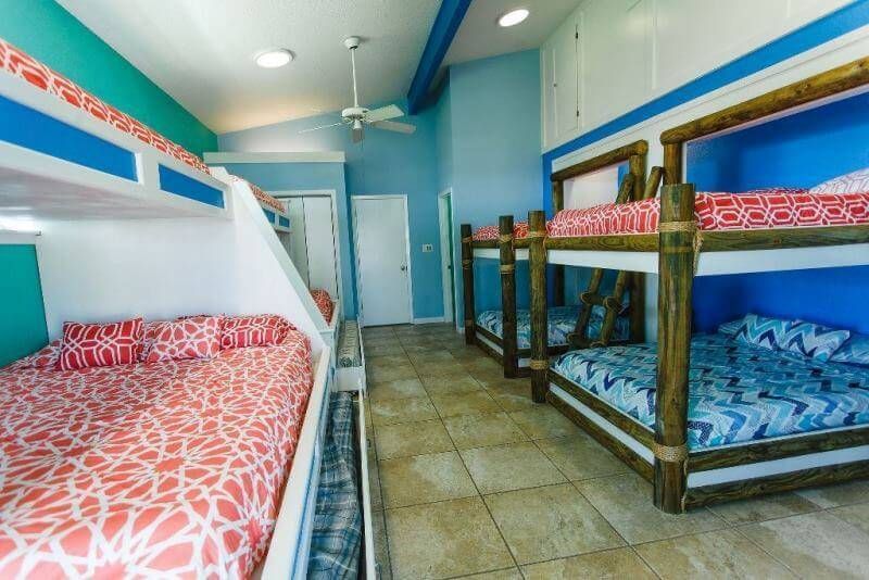 A room with bunk beds and a ceiling fan