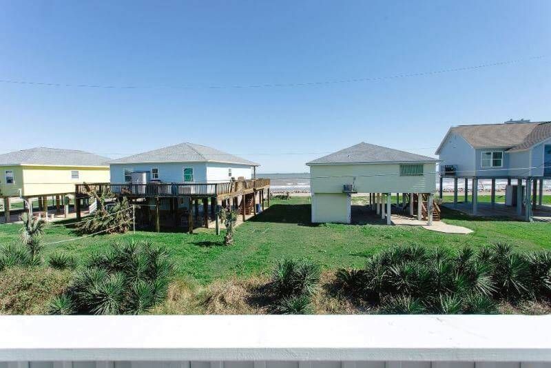 A group of houses sitting on top of a lush green field.