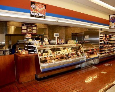 A grocery store with a sign that says super slice
