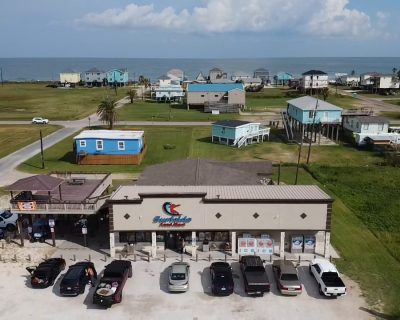 An aerial view of a store with cars parked in front of it