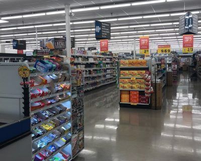 The inside of a grocery store with lots of shelves
