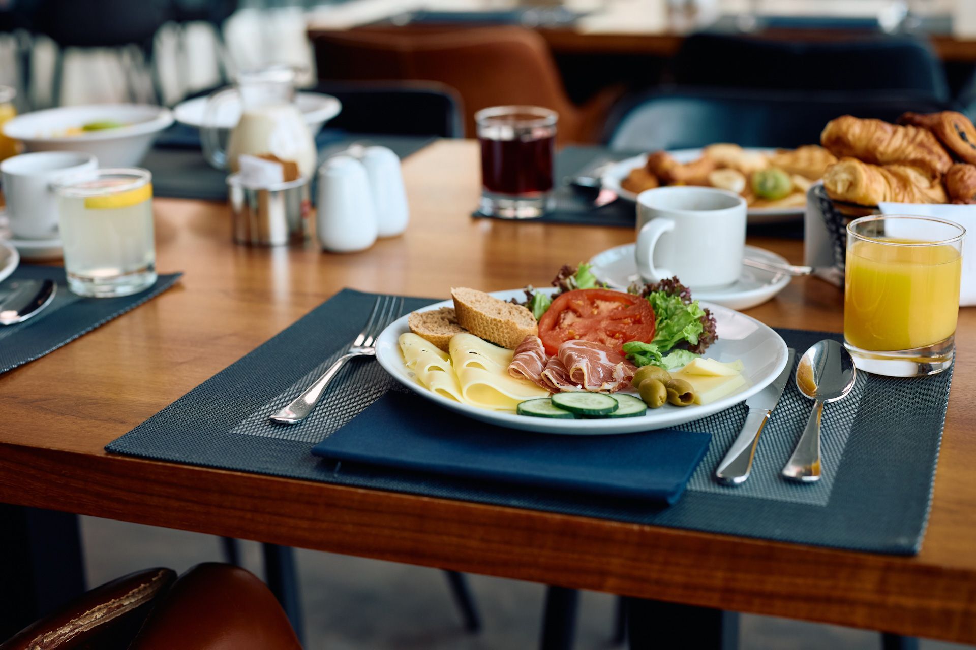 There is a plate of food on the table with utensils.