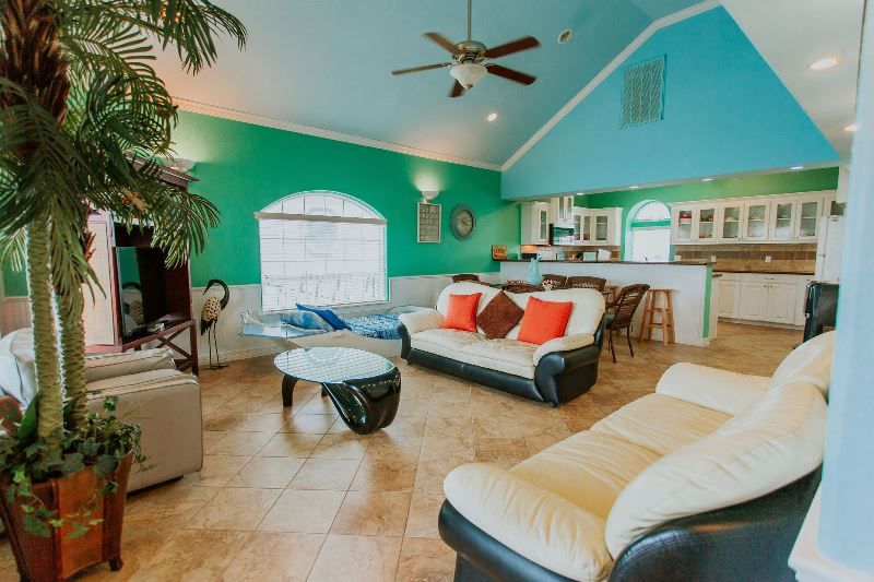 A living room filled with furniture and a ceiling fan.