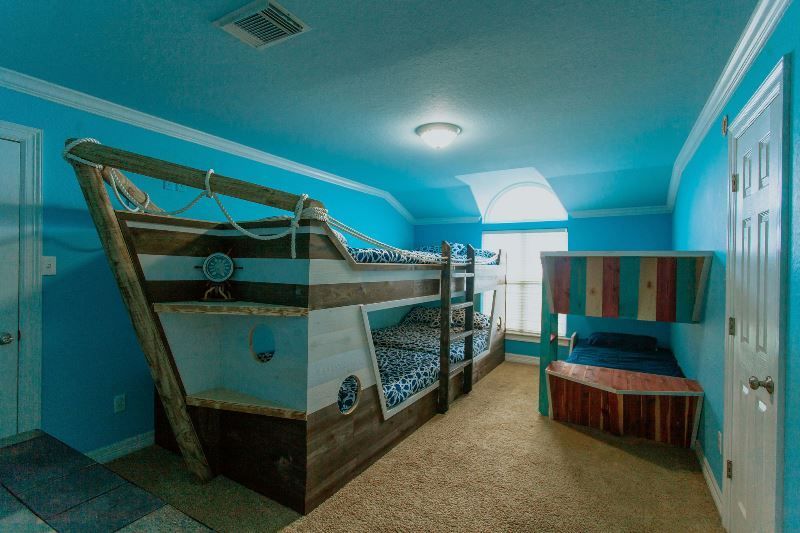A bedroom with bunk beds in the shape of a boat.