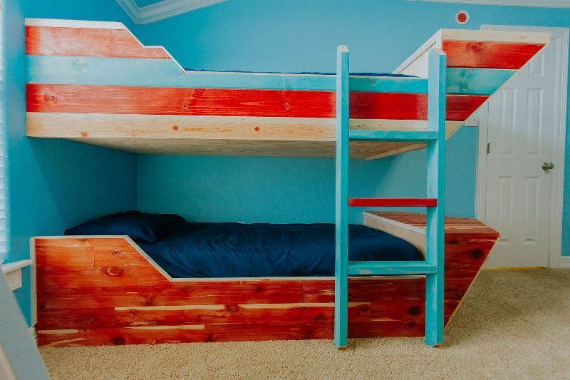 A wooden bunk bed in the shape of a pirate ship.