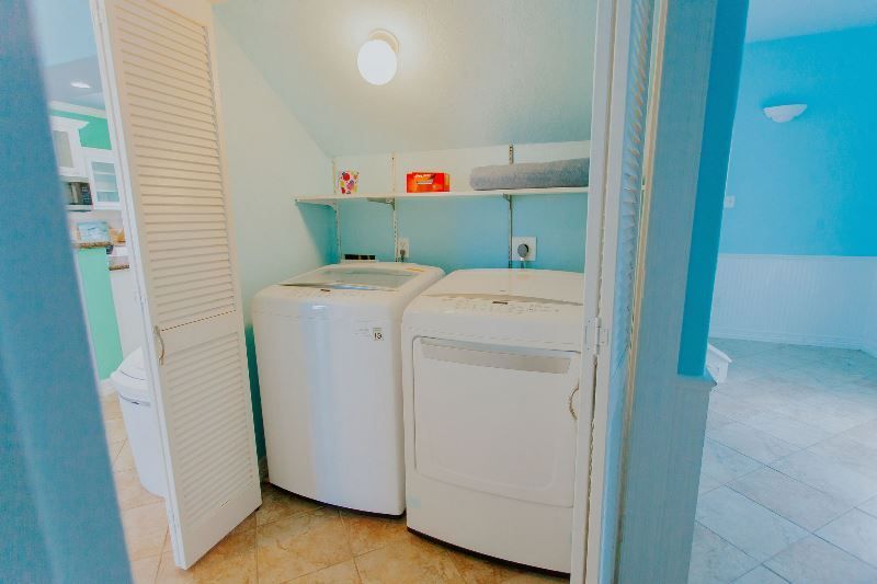A laundry room with a washer and dryer in a closet.