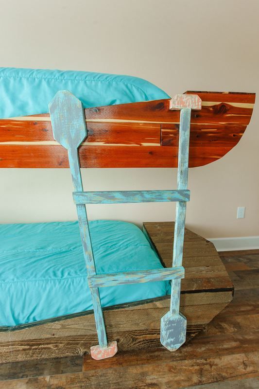 A bunk bed with a ladder in the shape of a boat.