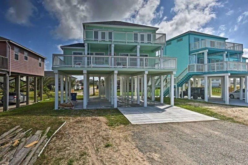 A group of houses are sitting on top of each other on stilts.