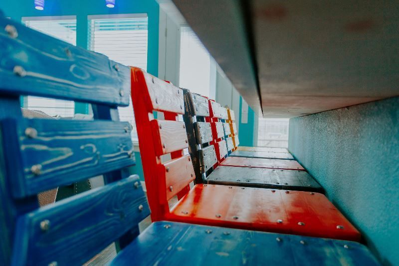 A row of colorful wooden chairs in a room.