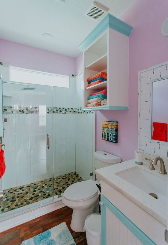 A bathroom with a toilet a sink and a shower