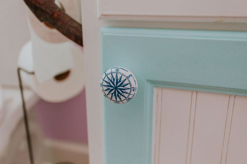 A close up of a door knob on a bathroom door.