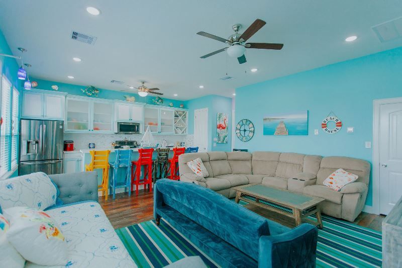 A living room filled with furniture and a ceiling fan.