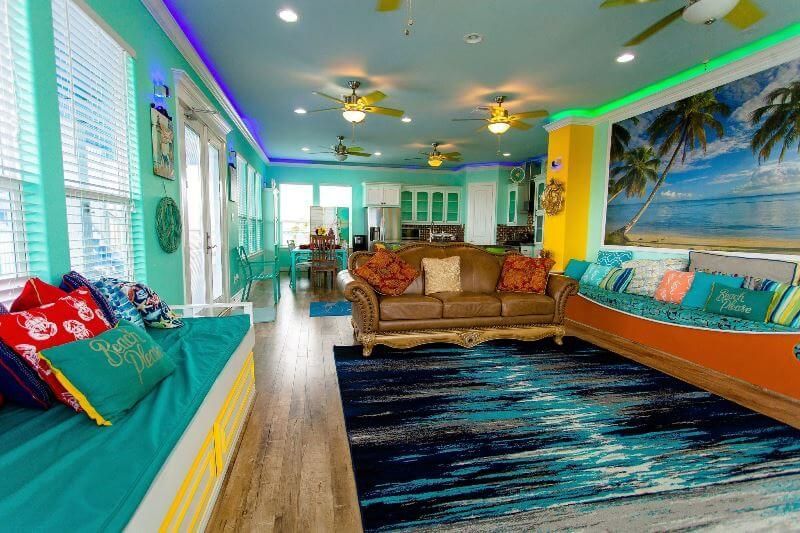 A living room with a couch and a boat shaped bench.