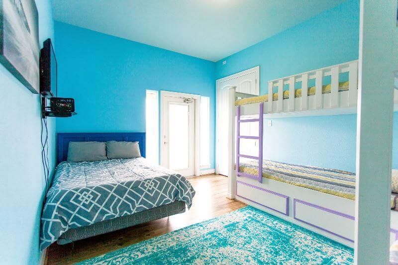 A bedroom with a bunk bed and a bed.