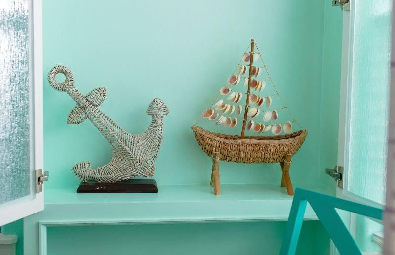There is an anchor and a boat on the shelf.
