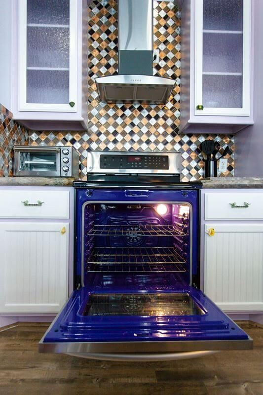 A kitchen with a blue stove with the door open
