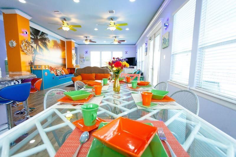 A dining table with plates and bowls on it in a living room.