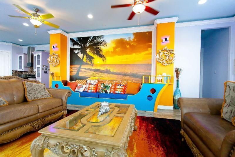A living room with a picture of a beach on the wall