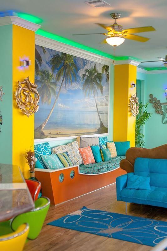 A living room with a blue couch and a ceiling fan
