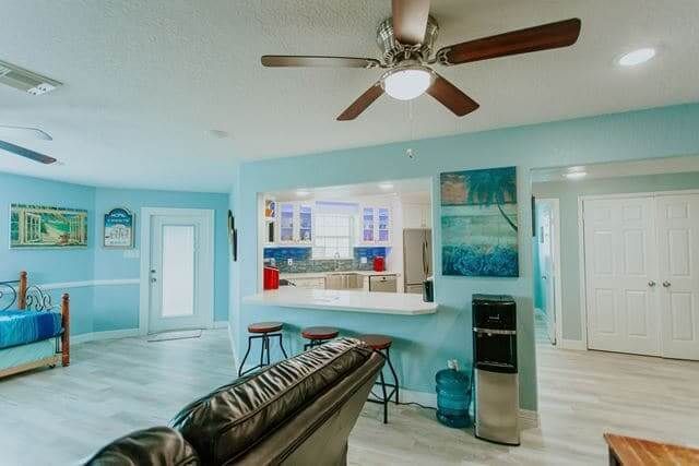 A living room with a ceiling fan and a couch