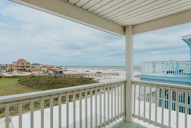 There is a balcony with a view of the ocean.
