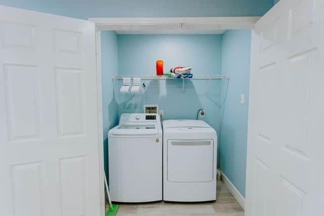 A laundry room with a washer and dryer in it.