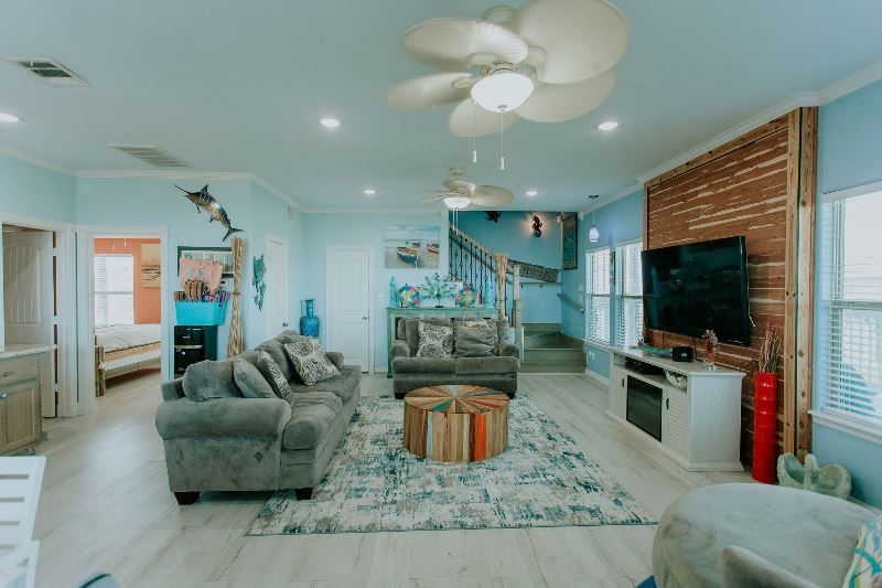 A living room filled with furniture and a ceiling fan.