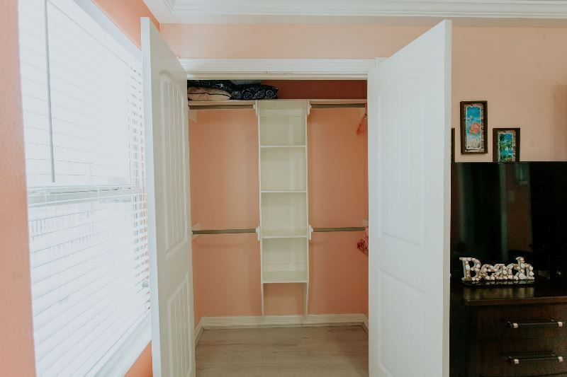 A walk in closet with a sign that says beach on it