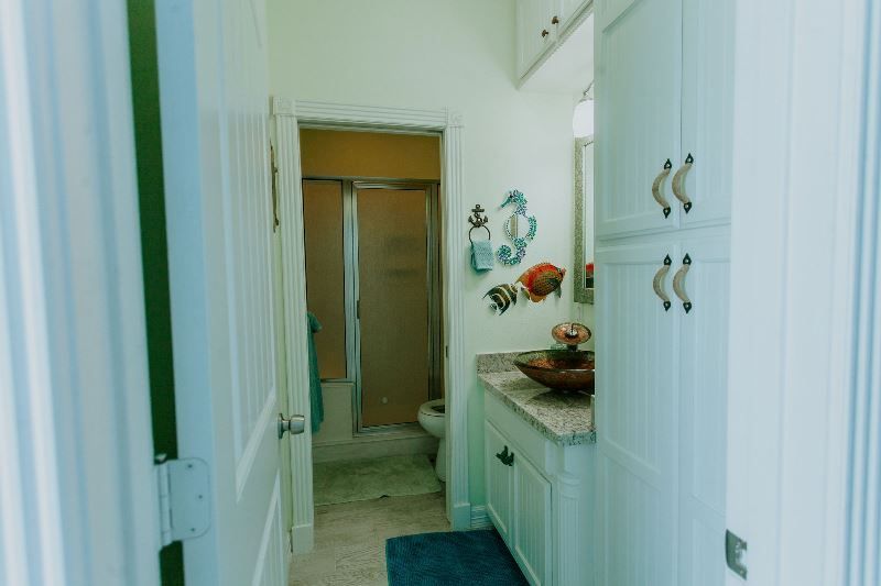 A bathroom with a sink , toilet and shower.