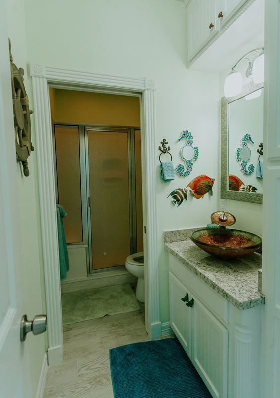 A bathroom with a sink a toilet and a shower