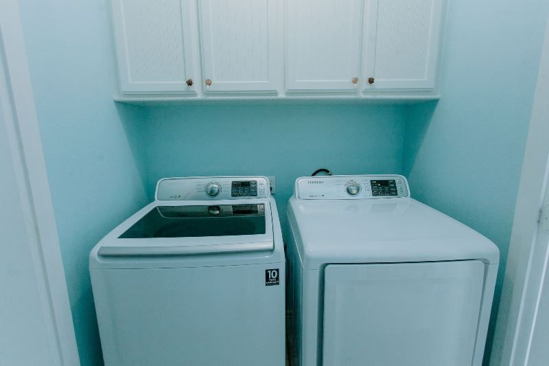 A laundry room with a washer and dryer in it.