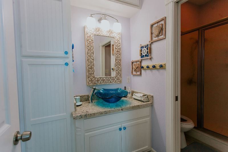 A bathroom with a sink , mirror , and toilet.