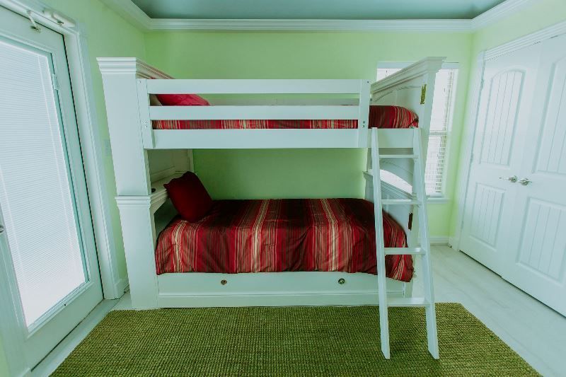 There is a bunk bed with a ladder in the middle of the room.