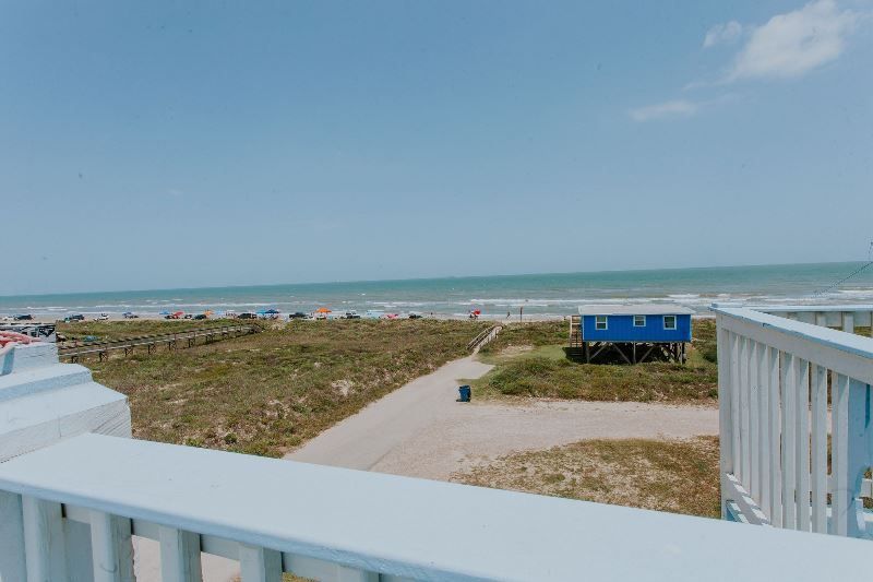 There is a view of the ocean from a balcony.