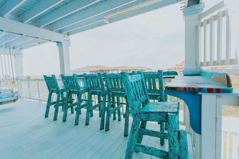 A deck with a table and chairs on it.