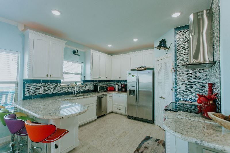 A kitchen with stainless steel appliances and granite counter tops.
