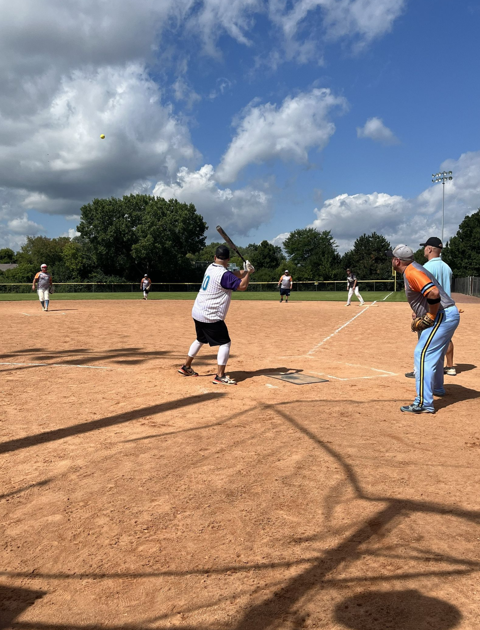 Basketball about to go through a hoop.