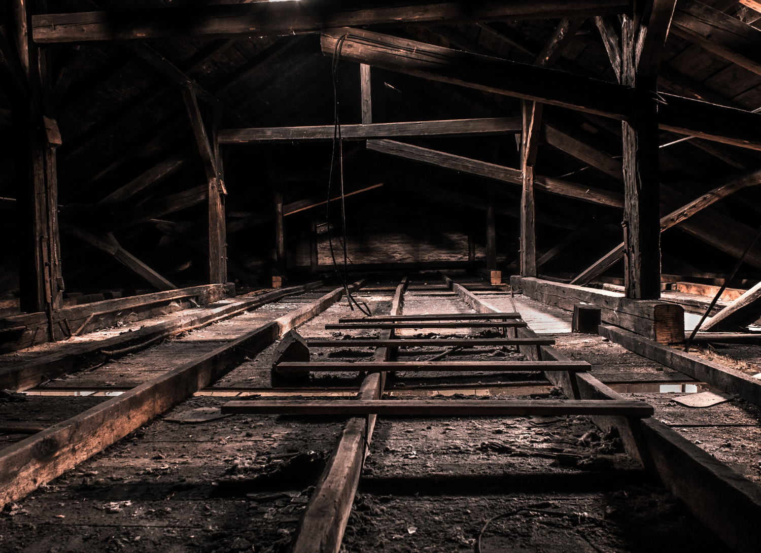 Dirty attic with exposed beams