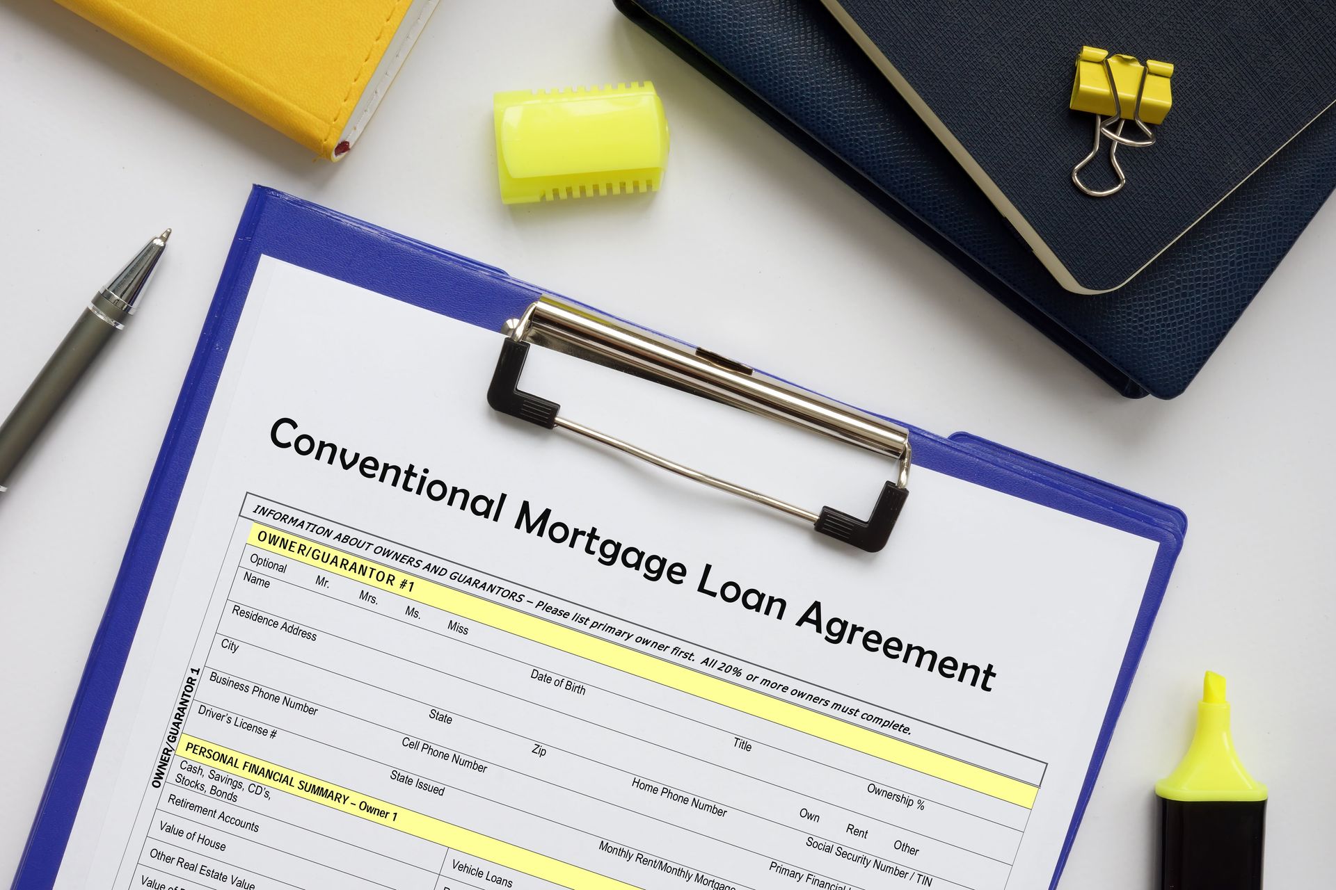 A clipboard with a conventional mortgage loan agreement on it