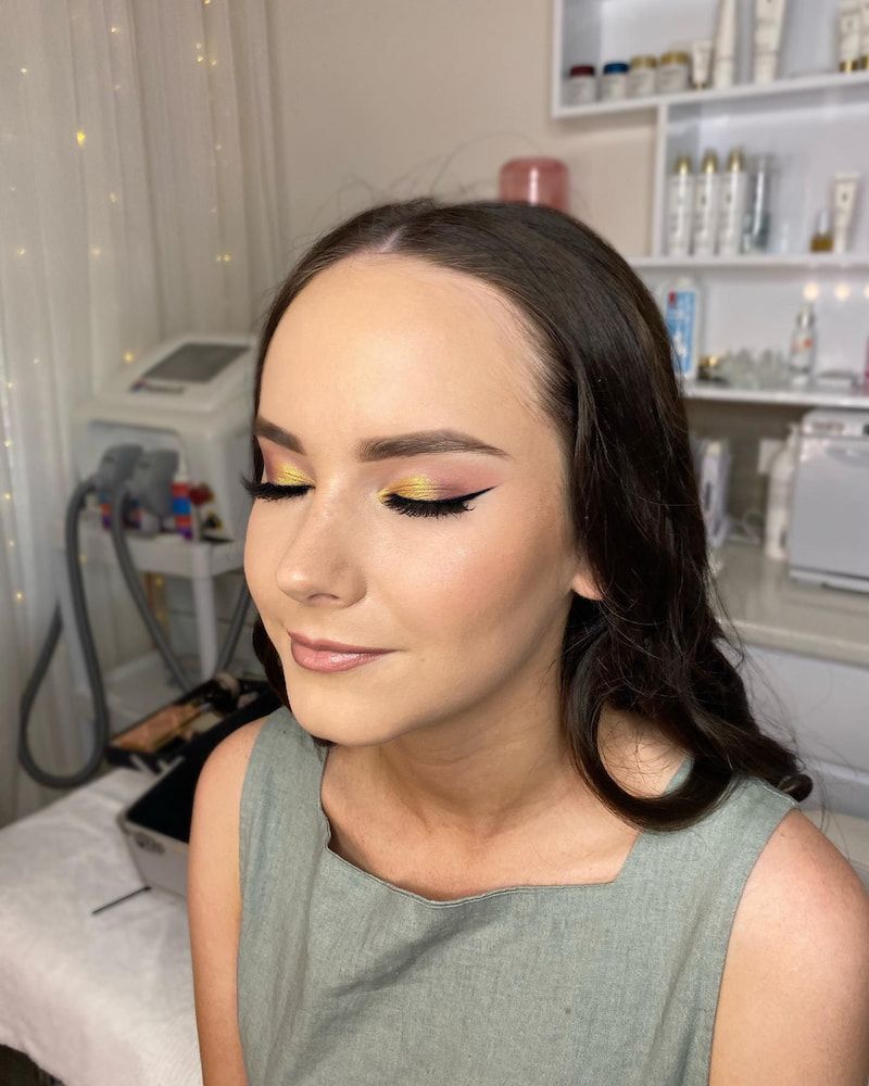 A Woman is Getting Her Makeup Done in a Beauty Salon — Erikka's All Occasion Beauty In Rockhampton City, QLD